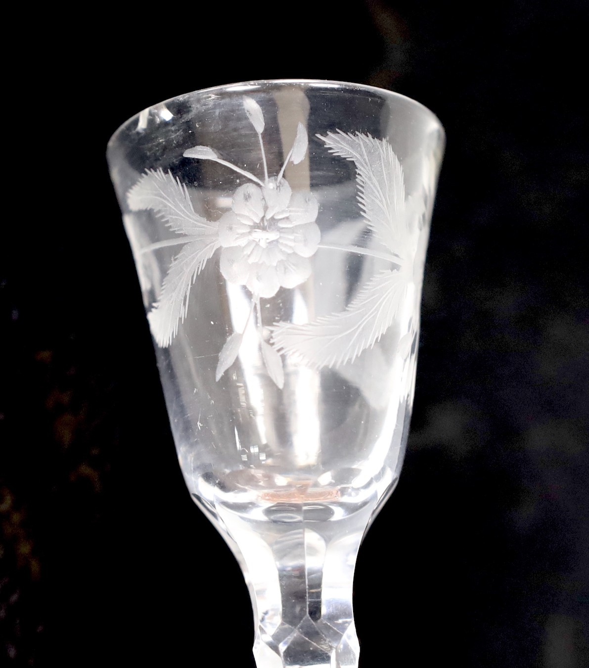 A George III facet stem wine or cordial glass, wheel engraved flowers. 16.5cm tall